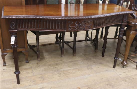 A George III style serpentine serving table W.153cm